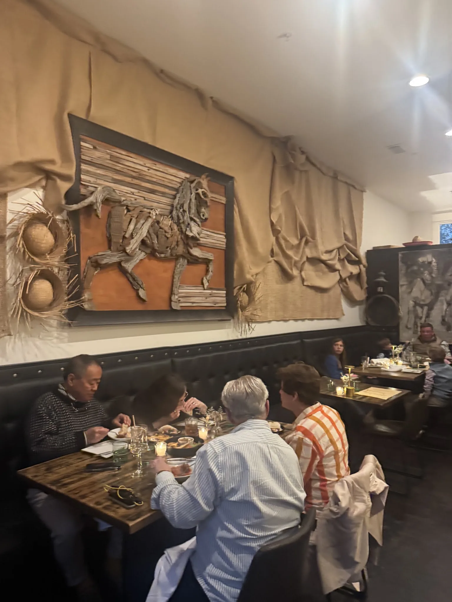 Guests dining beneath the horse relief in the Criollo dining room